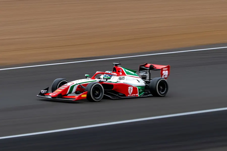 A 2026 Formula 3 car at speed on track, panned against a blurred background
